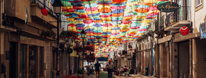 Street in Portugal with umbrellas covering the footpath