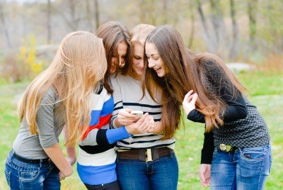 Teens looking at a phone